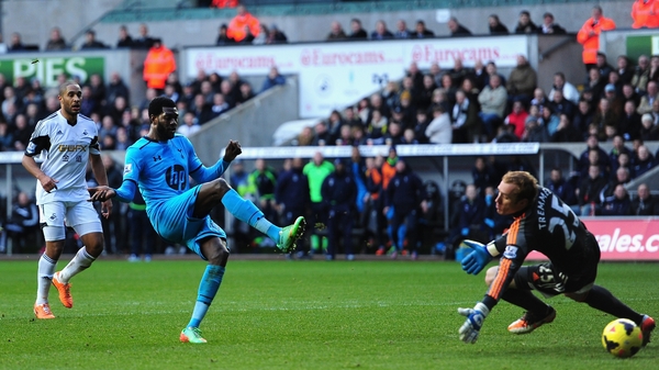 Emmanuel Adebayor rolls in Spurs third goal at Swansea