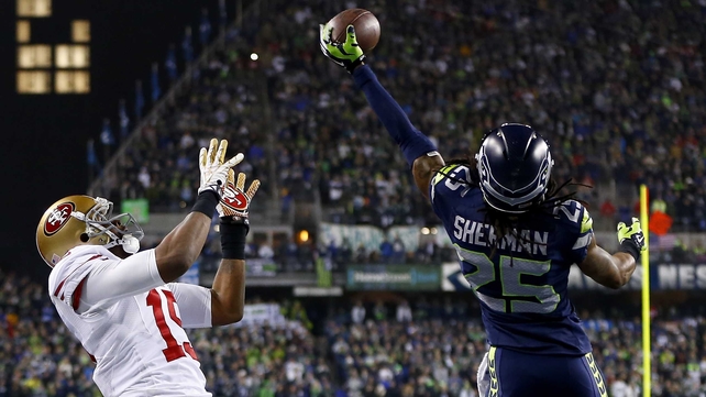 Richard Sherman of Seattle tips the ball leading to an intereption by Malcolm Smith to beat San Francisco 49ers in Seattle
