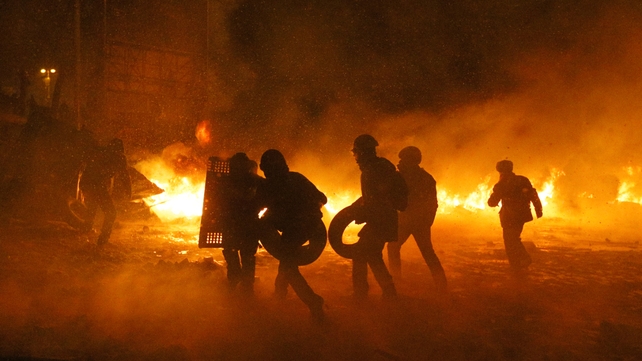 Protesters collect tires to keep the flaming barricade going (Pic: EPA)