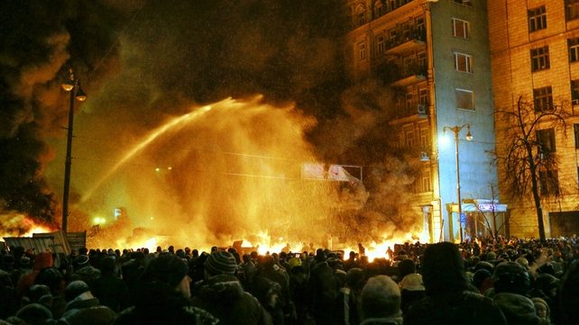 Police use water cannon to try to put out a fire of burning tires (Pic: EPA)