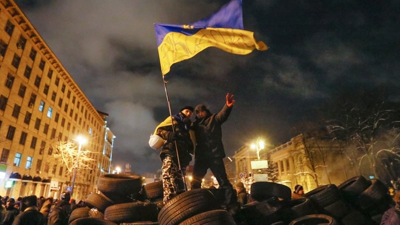 Protesters stand on top of a barricade in Kiev (Pic: EPA)