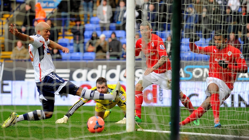 Cardiff City's Fraizer Campbell (R) scores during his side's encounter with Bolton