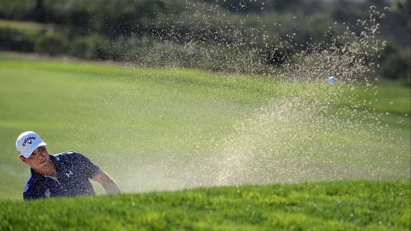 Gary Woodland plays from the bunker on the 17th