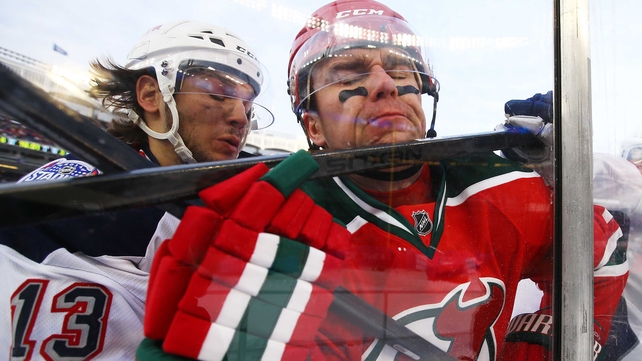 Daniel Carcillo #13 of the New York Rangers checks Marek Zidlicky of the New Jersey Devils in the NHL