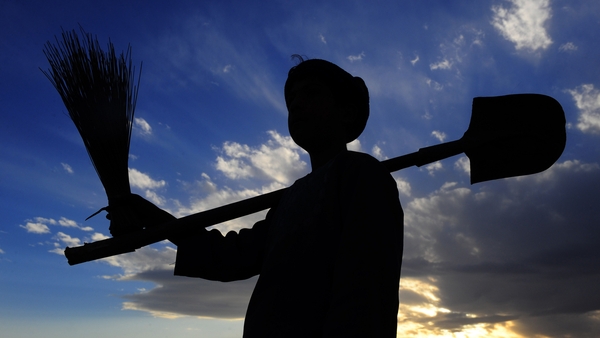 An Afghan farmer walks at sunset in Herat