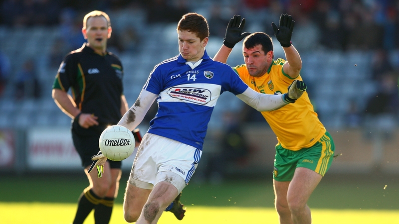 Evan O'Carroll of Laois gets his shot away under pressure from Frank McGlynn