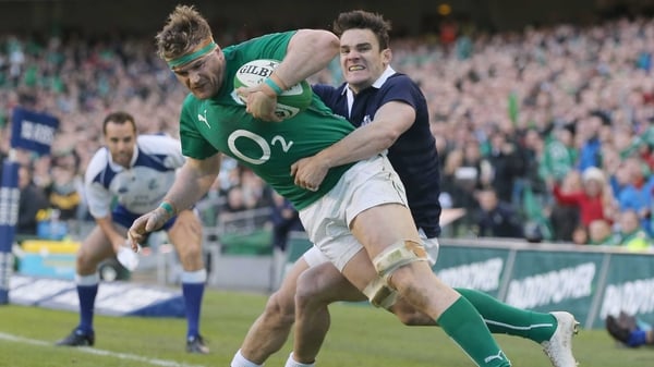 Max Evans of Scotland tackles Jamie Heaslip