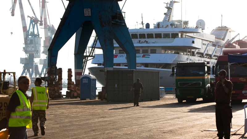 Israeli soldiers and port workers stand next to the Mavi Marmara, at Ashdod Port