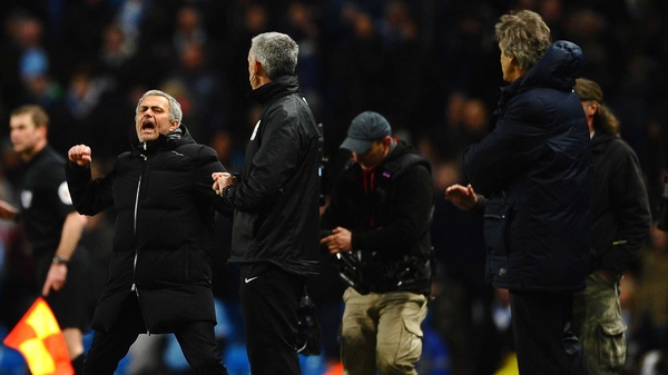 Jose Mourinho (L) celebrates victory as Manuel Pellegrini looks on
