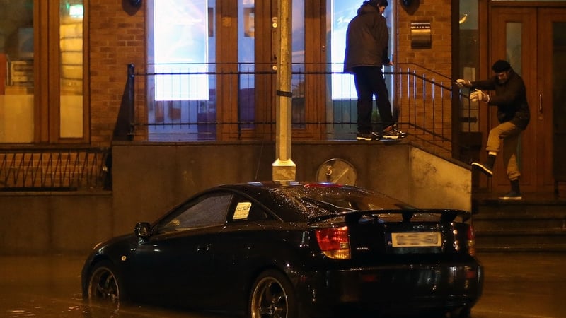 A car is abandoned in flood water in Cork as much of the city centre flooded last night