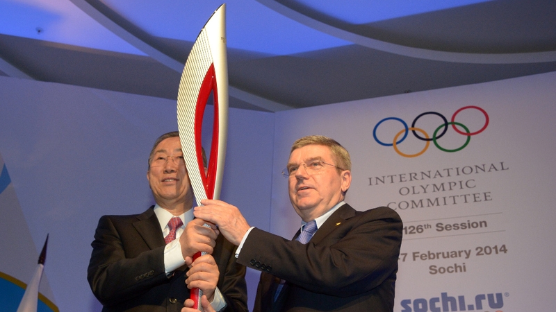 UN Secretary-General Ban Ki-Moon (L) and International Olympic Committee president Thomas Bach with the Olympic torch