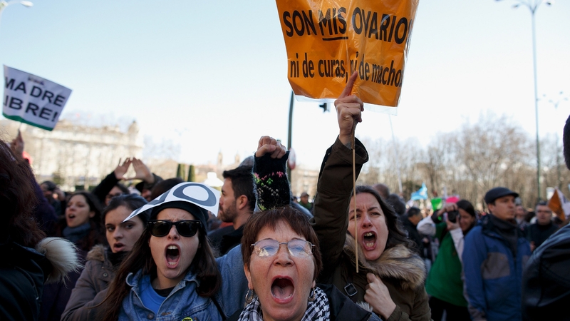 Protesters shout slogans and hold a placard reading 'they are my ovaries, nor of priest, nor of males' during a pro-choice protest in Madrid