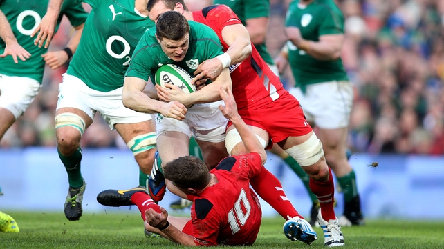 130 caps and still going strong: Brian O'Driscoll drives through the Welsh defence