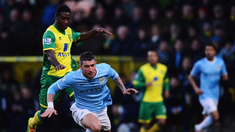 Alexander Tettey of Norwich tackles Aleksandar Kolarov of Manchester City
