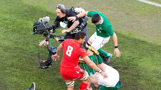 A cameraman comes off worst as Toby Faletau is driven into touch