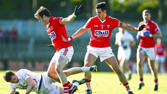 Kildare's Eoghan O'Flaherty is tackled by James Loughrey and Tom Clancy of Cork