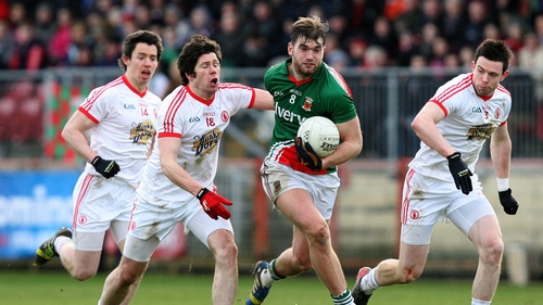 Seán Cavanagh in pursuit of Aidan O'Shea in Healy Park
