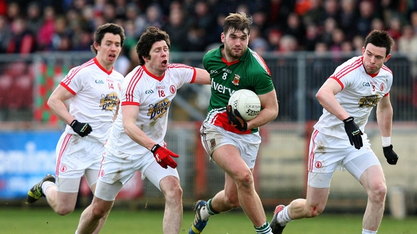 Seán Cavanagh in pursuit of Aidan O'Shea in Healy Park