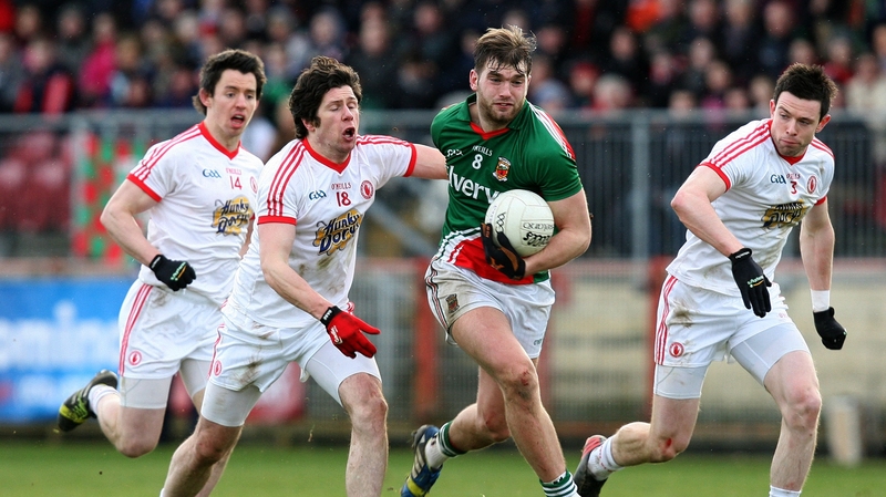Seán Cavanagh in pursuit of Aidan O'Shea in Healy Park