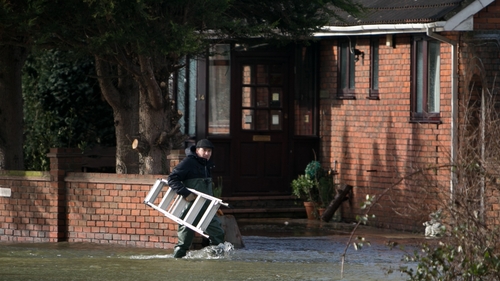 A man outside his flooded property after the River Thames overflowed its bank in Chertsey, Surrey