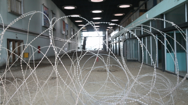 Barbed wire covers the entrance to the main hall
