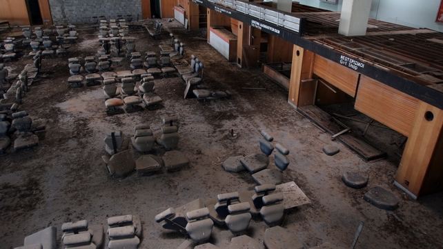 Broken chairs litter the departure lounge