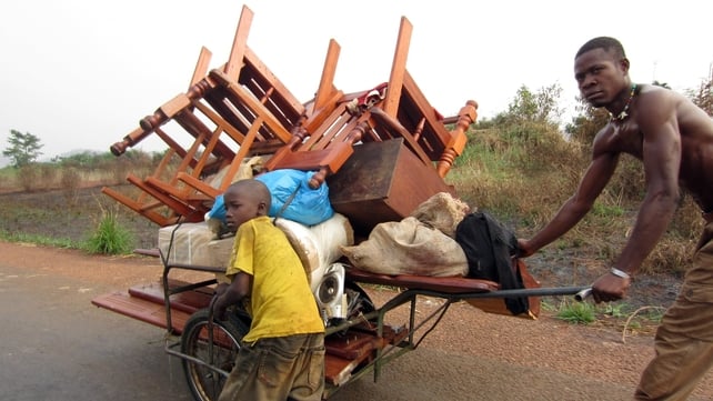 Locals pushing belongings on a cart in an area north of Bangui, Central African Republic. According to reports, Christian residents looted homes of Muslim neighbours who were forcibly displaced during the clashes in the north of Bangui