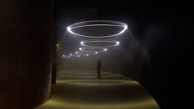 Visitors enjoy the 'United Visual Artists: Momentum' installation at The Curve at the Barbican Centre, London