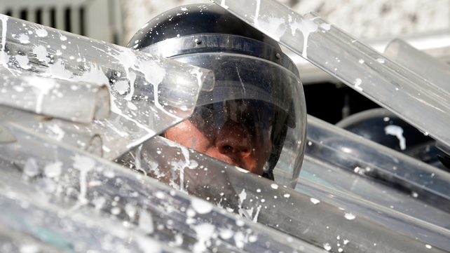 Riot policemen protect themselves during an opposition demo against the government of Venezuelan President Nicolas Maduro in Caracas