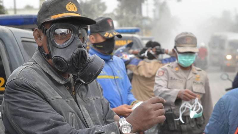Police distribute face masks to residents on the streets of Malang