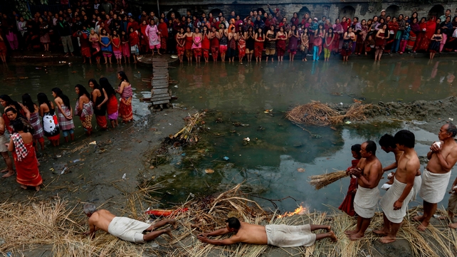 Hindu devotees roll on the ground before taking a holy bath in the Hanumante river during the final day of the month long Madhav Narayan fasting festival, in Bhaktapur, on the outskirts of Kathmandu, Nepal (Pic: EPA)
