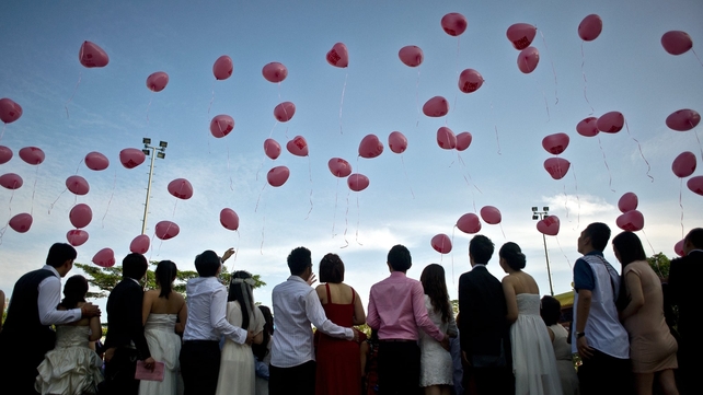 Newly-wed ethnic Malaysian-Chinese couples release heart-shaped balloons during their mass wedding ceremony on Valentine's Day at the Thean Hou Temple in Kuala Lumpur
