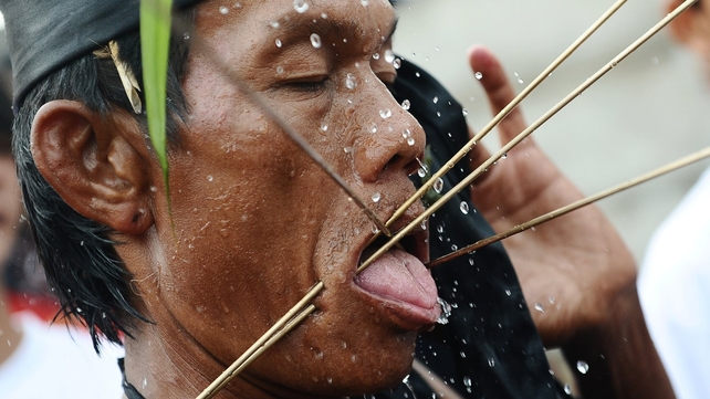 A Tatung pierces metal needles trough his cheeks during the Tatung Festival as part of Cap Go Meh celebrations in Singkawang, Kalimantan, Indonesia. The ancient art of Tatung is believed to call upon positive spirit who help to dispel the bad spirits that