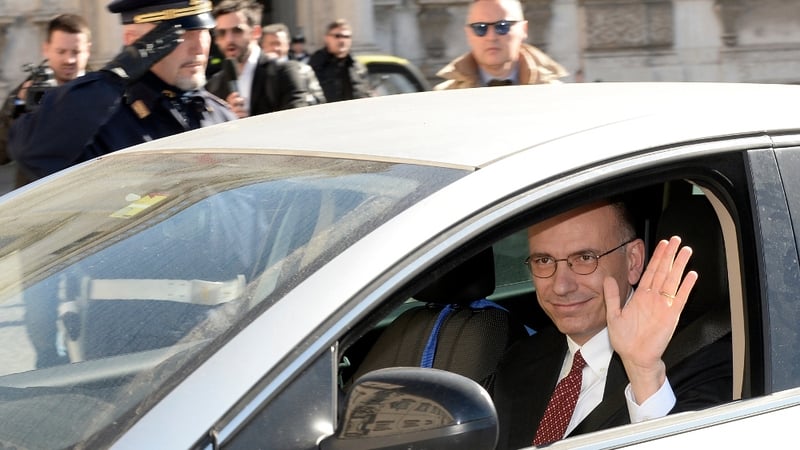 Enrico Letta waves as he arrives at Quirinale palace in Rome to formally submit his resignation
