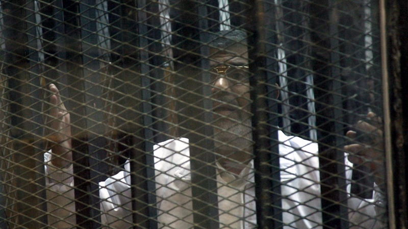 Mr Mursi's legal team protested they could not hear their client speak from inside a soundproof glass cage