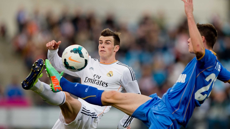 Gareth Bale (left) competes for the ball with Martin Vigaray of Getafe