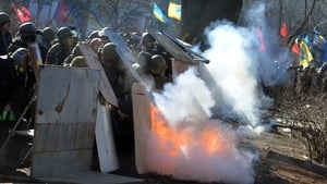 Police shelter behind riot gear