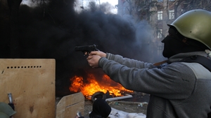 A protester aims a gun at police (Pic: EPA)