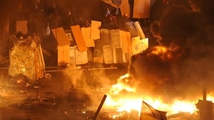 Protesters protect themselves with shields against advancing riot police forces moving on Independence Square (Pic: EPA)