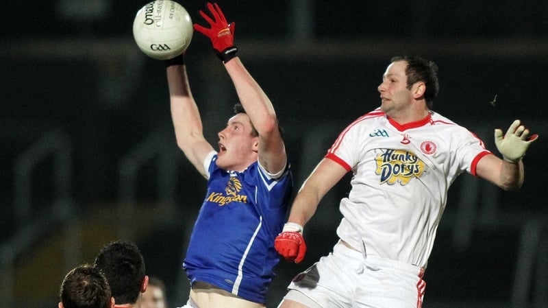 Tyrone's Ronan McNabb with Cavan's Michael Argue