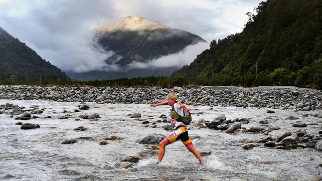 A competitor gets her feet wet during the one-day individual event at the Speights Coast to Coast in Christchurch, New Zealand