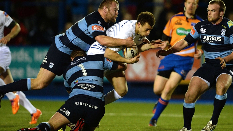 Zane Kirchner is brought to ground by two Blues tacklers