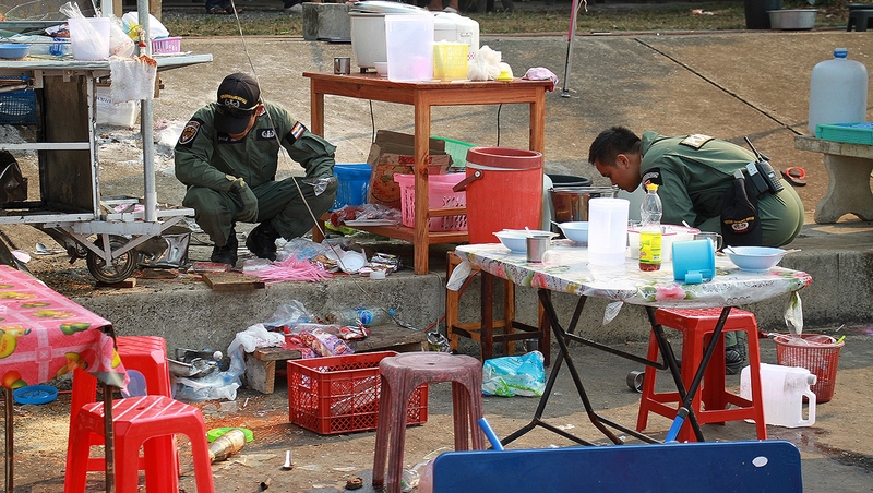Members of a bomb squad unit inspect the site of an attack near an anti-government rally in Trat province