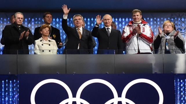 Former IOC president Jacques Rogge, current IOC president Thomas Bach (centre-left), Russia's President Vladimir Putin (centre-right) and double-gold medallist and bobsleigh pilot Alexander Zubkov (white jacket) watch on from the stands