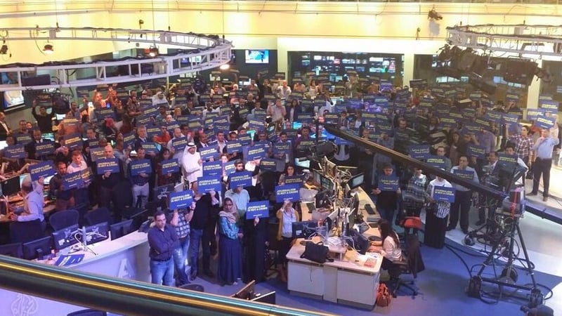 Dozens of staff of the Doha-based satellite news channel staged a five-minute gathering at the network's headquarters (@AJEnglish)