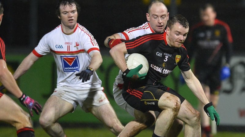 Down's Brendan McArdle is put under pressure