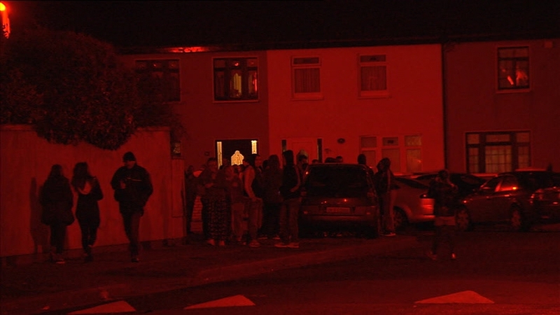People gathered outside his brother's home where he was shot before 6pm this evening