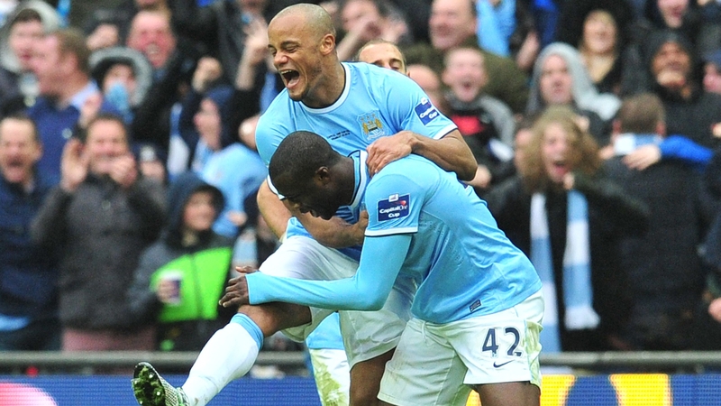 Vincent Kompany celebrates with Yaya Toure's after Toure's stunning goal for Man City