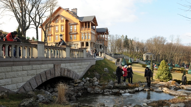 Visitors walk near the luxury residence, located near Kiev