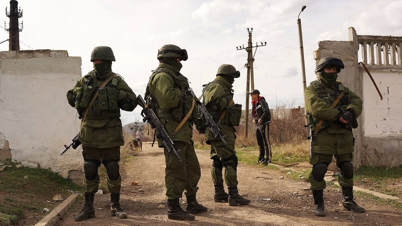 Pro-Russian forces stand guard outside a Ukrainian military base near the Crimean city of Simferopol